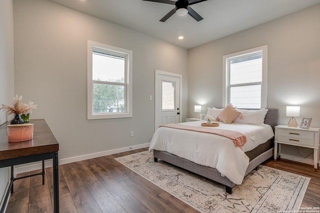 bedroom with multiple windows, ceiling fan, and dark hardwood / wood-style floors