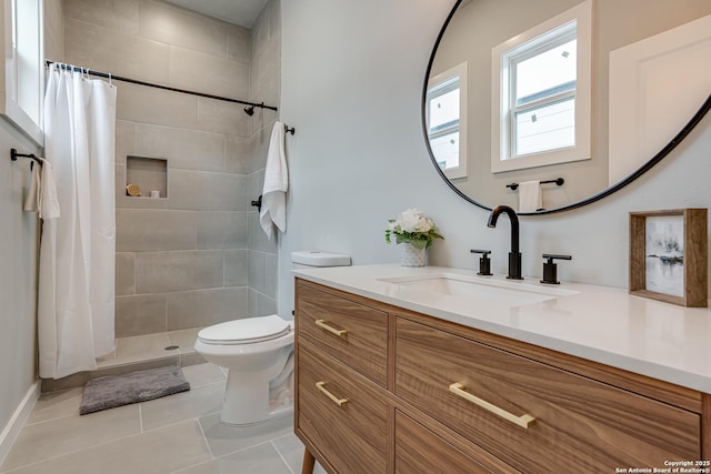 bathroom with tile patterned flooring, vanity, toilet, and walk in shower