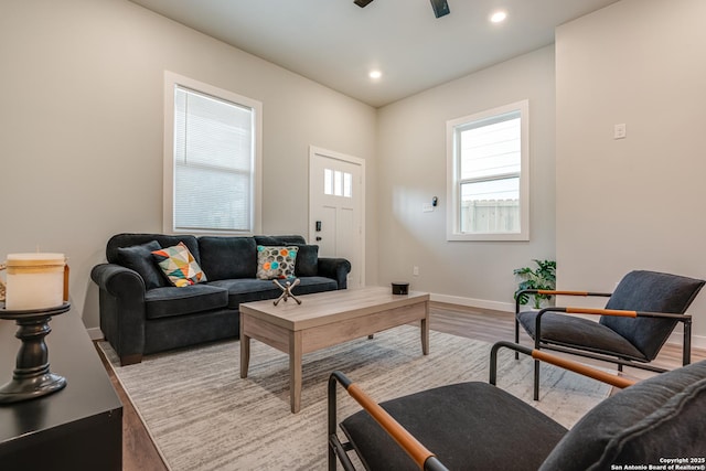 living room featuring ceiling fan and light wood-type flooring