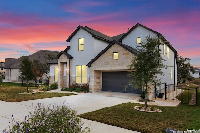 view of front of property with a yard and a garage