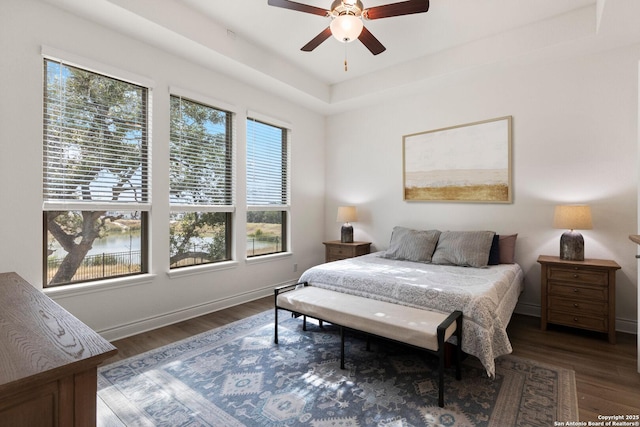 bedroom featuring dark hardwood / wood-style flooring and ceiling fan