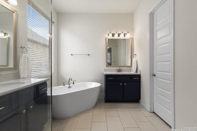 bathroom featuring a washtub and vanity