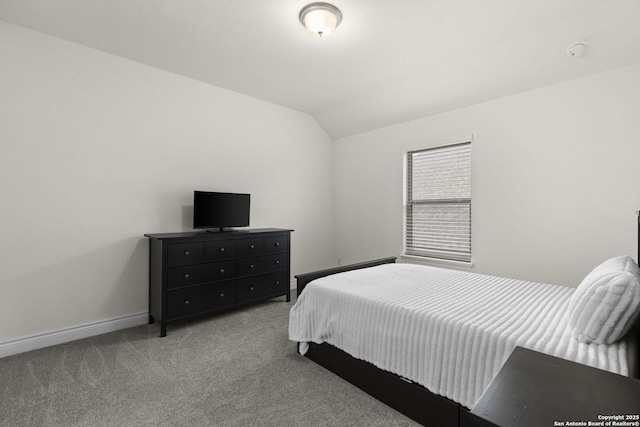 carpeted bedroom featuring vaulted ceiling