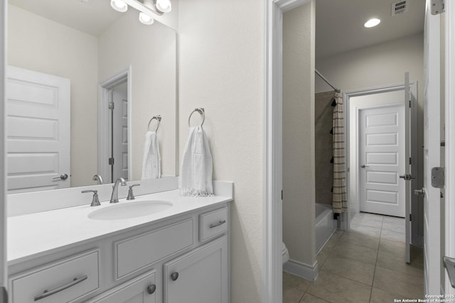 bathroom with tile patterned flooring, vanity, and shower / tub combo