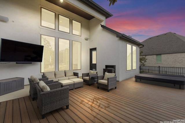 deck at dusk with an outdoor hangout area