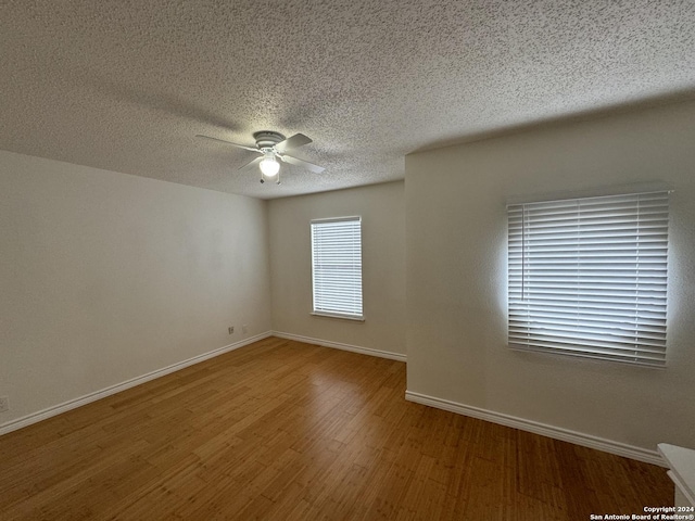 spare room featuring ceiling fan, a textured ceiling, and hardwood / wood-style flooring