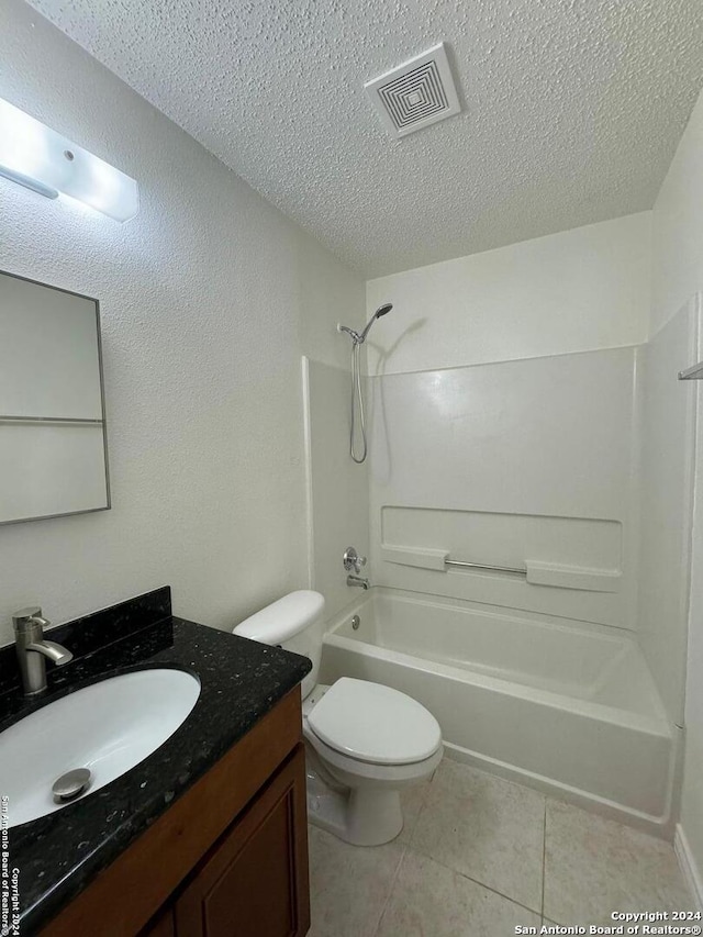 full bathroom featuring a textured ceiling, vanity,  shower combination, and toilet