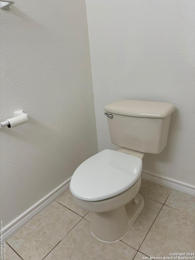 bathroom with tile patterned flooring and toilet