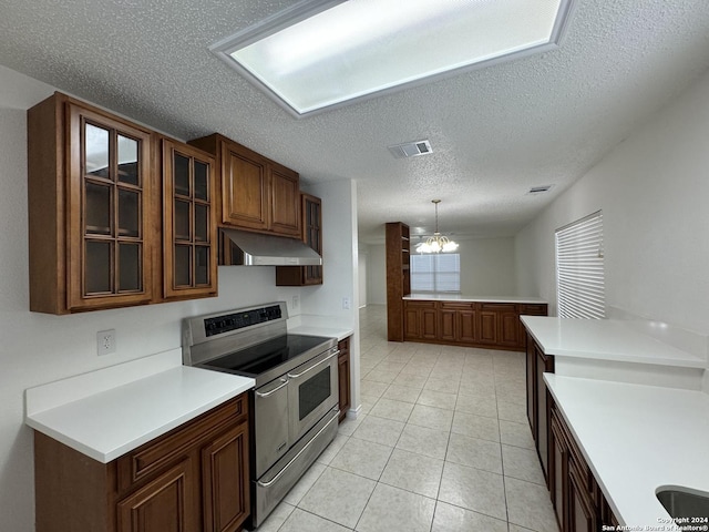 kitchen featuring hanging light fixtures, a notable chandelier, double oven range, a textured ceiling, and light tile patterned floors