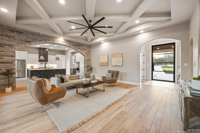 living room with beam ceiling, light hardwood / wood-style floors, and coffered ceiling