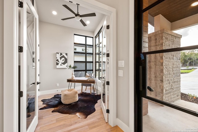 bathroom featuring hardwood / wood-style flooring, ceiling fan, and french doors