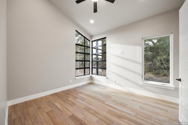 unfurnished room featuring ceiling fan, light hardwood / wood-style flooring, and vaulted ceiling