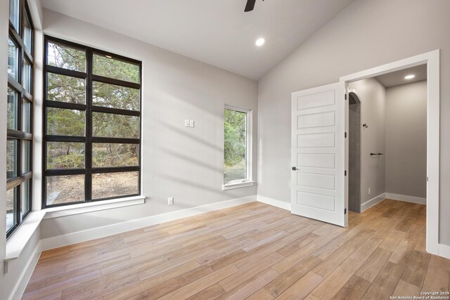 unfurnished room featuring ceiling fan, light hardwood / wood-style floors, and high vaulted ceiling