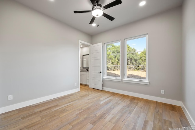 spare room with light wood-type flooring and ceiling fan