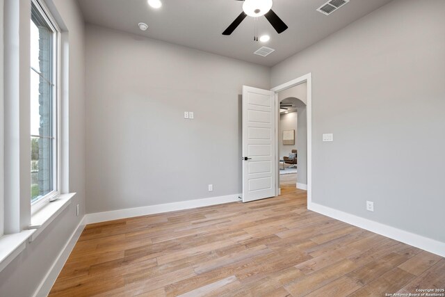 unfurnished room with ceiling fan and light hardwood / wood-style flooring