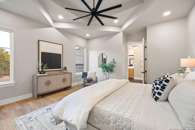 bedroom featuring ensuite bath, ceiling fan, and light hardwood / wood-style floors