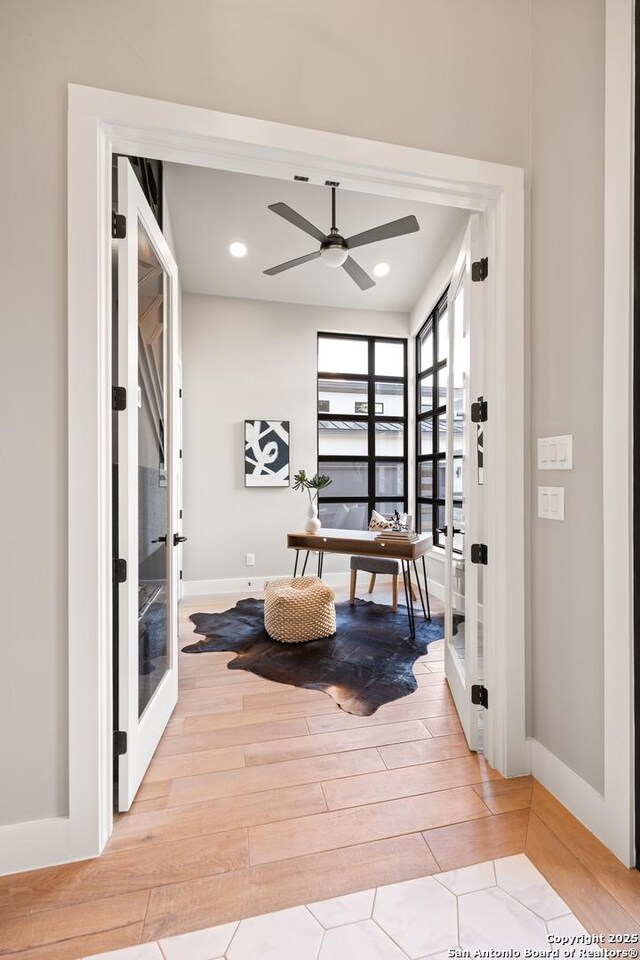 interior space with french doors and ceiling fan