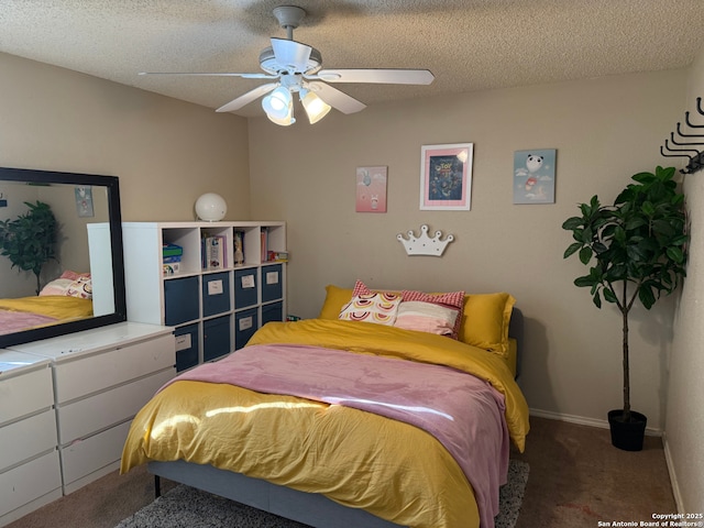 bedroom with ceiling fan, carpet floors, and a textured ceiling