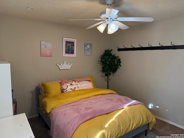 bedroom featuring ceiling fan, dark carpet, and a textured ceiling