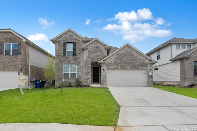 front facade featuring a garage and a front lawn