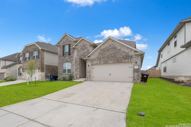 view of front of home with a front yard and a garage