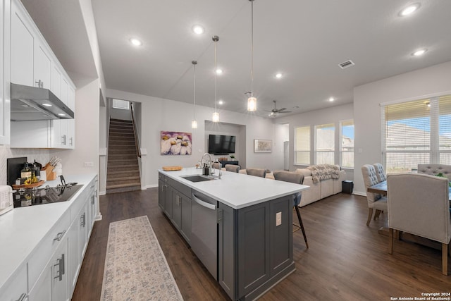 kitchen featuring dishwasher, a kitchen island with sink, white cabinets, sink, and ceiling fan