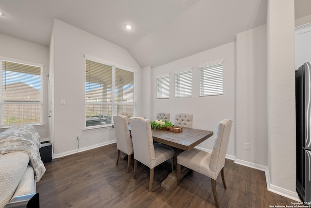 dining area featuring dark hardwood / wood-style flooring and lofted ceiling