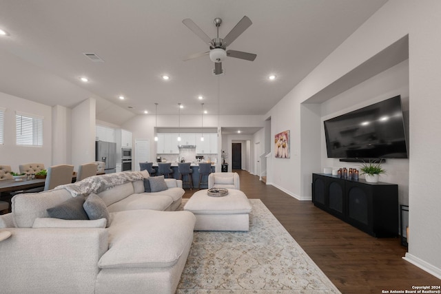 living room featuring ceiling fan, dark hardwood / wood-style flooring, and lofted ceiling