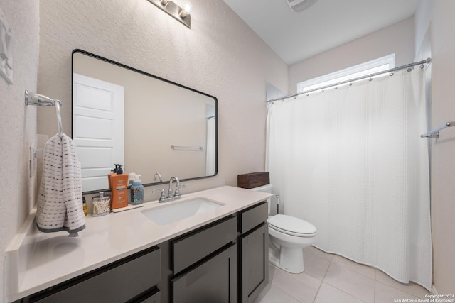 bathroom featuring tile patterned floors, vanity, and toilet