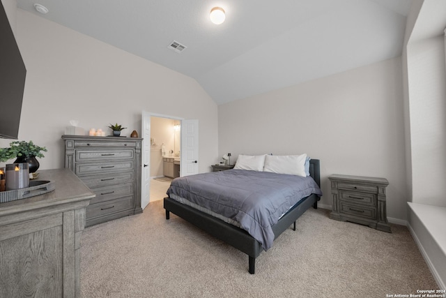 bedroom featuring connected bathroom, light colored carpet, and lofted ceiling