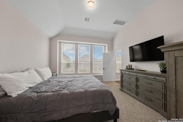 carpeted bedroom featuring lofted ceiling