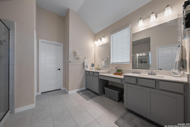 bathroom featuring tile patterned floors, a shower with door, vanity, and vaulted ceiling