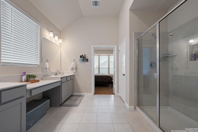 bathroom with tile patterned floors, vanity, vaulted ceiling, and an enclosed shower