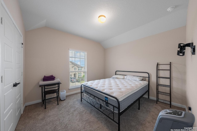 carpeted bedroom with vaulted ceiling