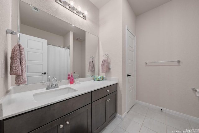 bathroom featuring tile patterned flooring and vanity