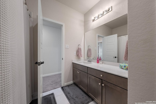 bathroom featuring tile patterned flooring and vanity