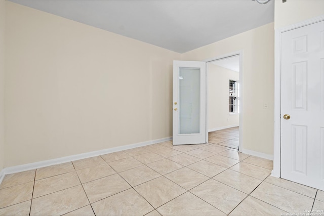 spare room with light tile patterned floors