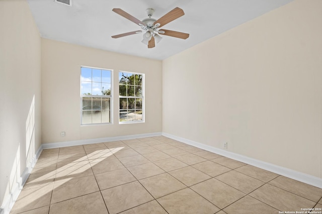 empty room featuring ceiling fan and light tile patterned floors