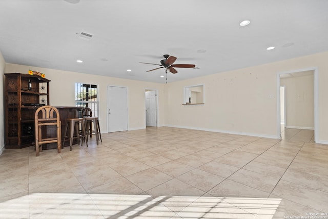 interior space with ceiling fan