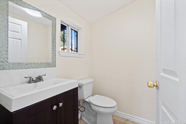 bathroom featuring tile patterned flooring, vanity, and toilet