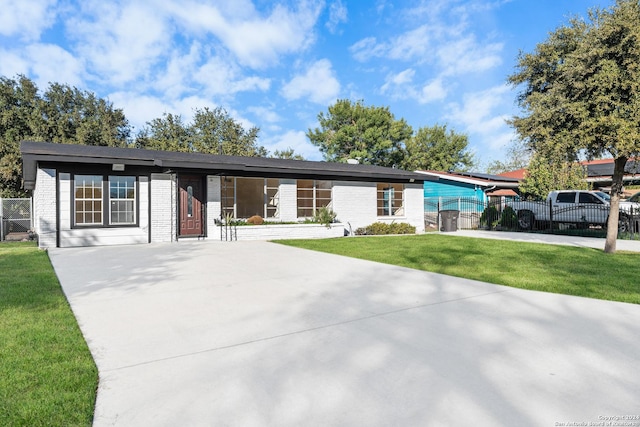 ranch-style house with a front lawn