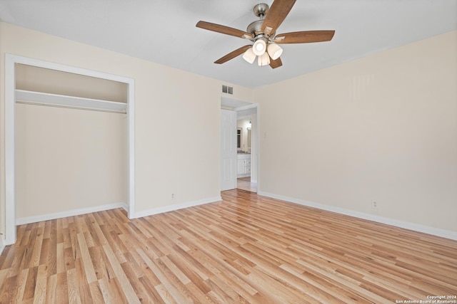 unfurnished bedroom with light wood-type flooring, a closet, and ceiling fan