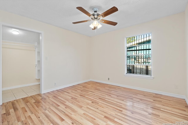 empty room featuring light hardwood / wood-style flooring and ceiling fan