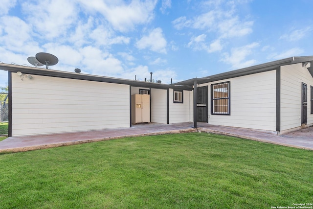 rear view of property featuring a yard