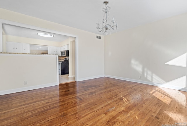 interior space with dark hardwood / wood-style flooring and a notable chandelier