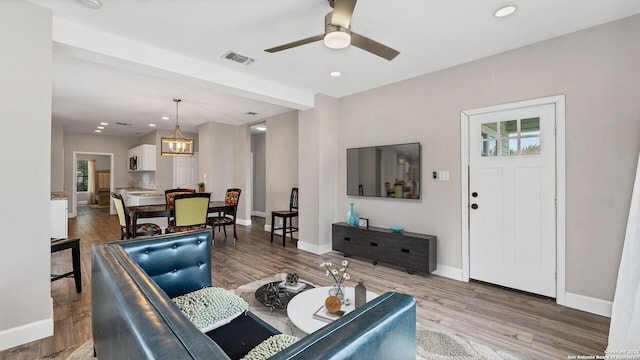 living room with hardwood / wood-style floors and ceiling fan