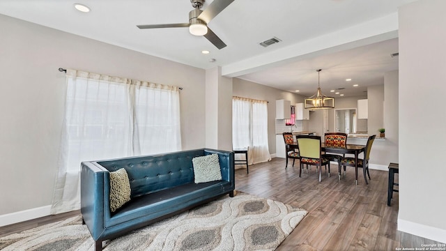 living room with hardwood / wood-style flooring and ceiling fan