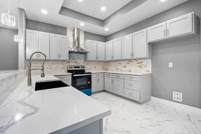 kitchen featuring pendant lighting, stainless steel electric range, wall chimney exhaust hood, light stone countertops, and tasteful backsplash