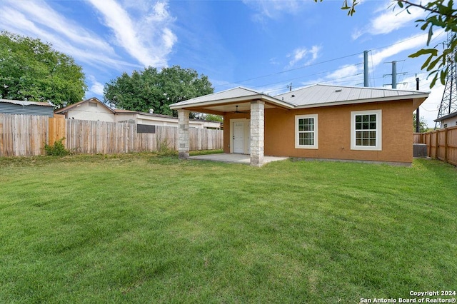 back of property featuring a patio and a lawn