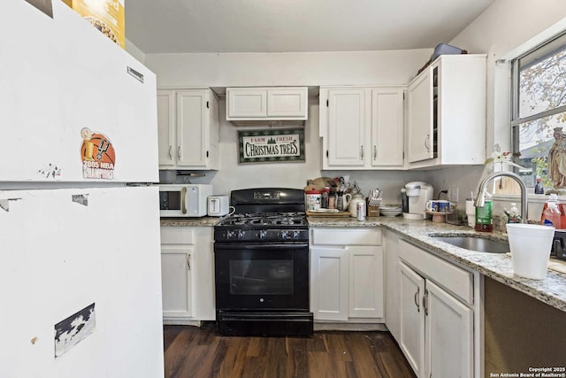 kitchen featuring black range with gas stovetop, sink, dark hardwood / wood-style floors, light stone counters, and white cabinetry